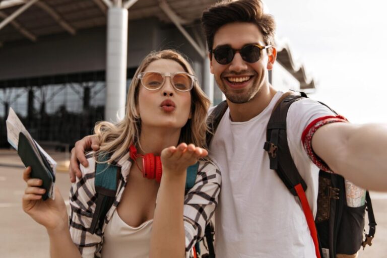 A couple taking a selfie at an airport terminal