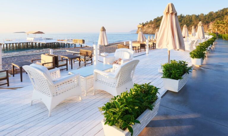 Seaside wedding venue setup in Cyprus with white chairs