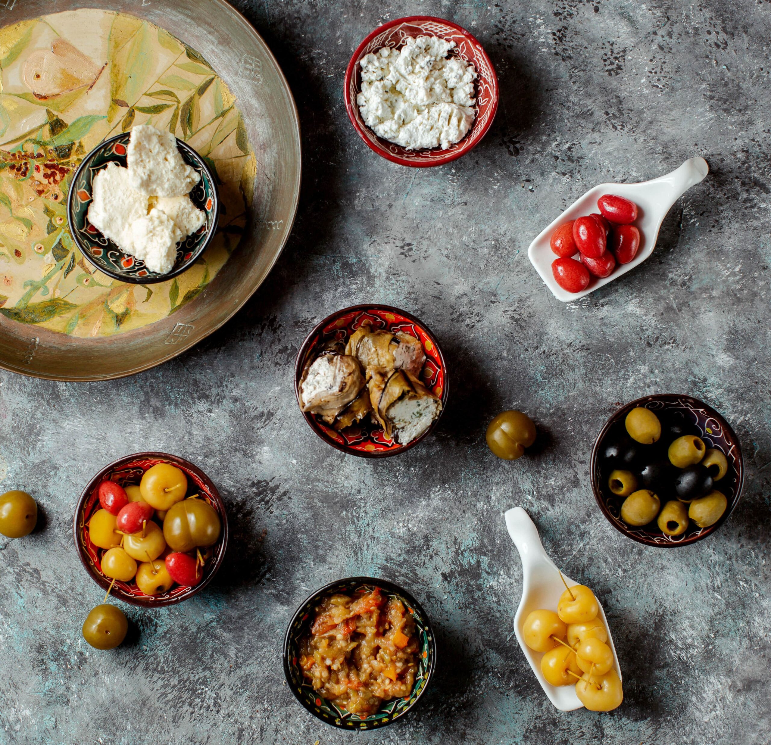 Traditional Cypriot meze with olives, dips, roasted vegetables, and soft cheese