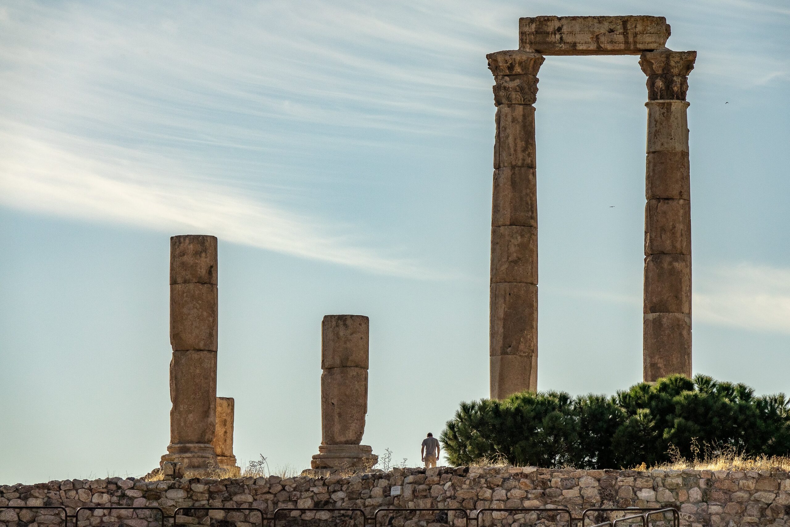 Ancient stone columns of a historical site in Cyprus with a person in the background