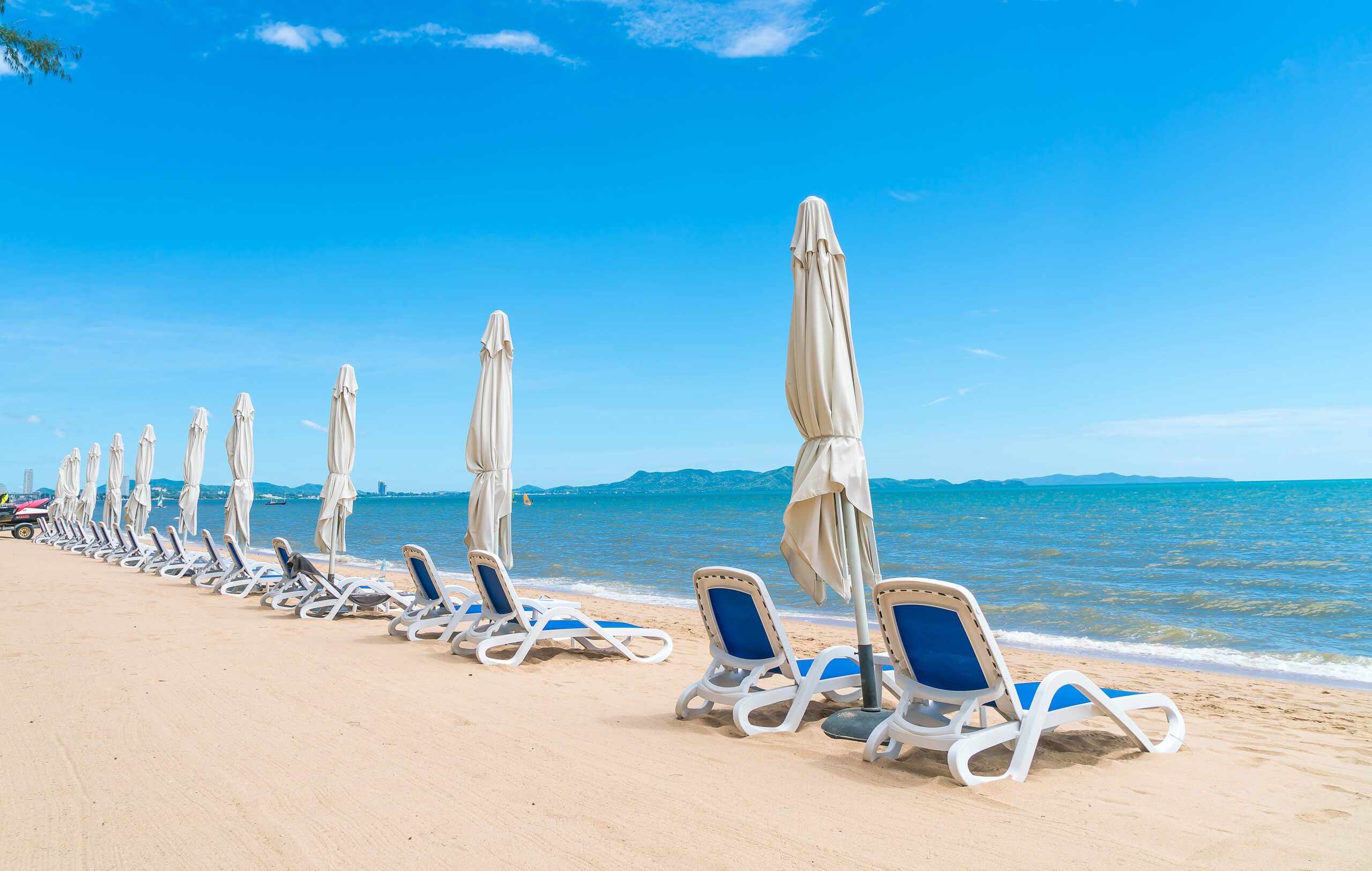 A sandy beach with ocean waves in the background in Cyprus