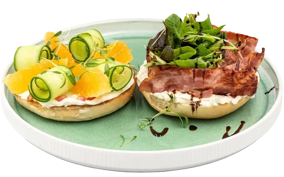 Bagels with crispy bacon, fresh greens, cucumber, and citrus for brunch in Larnaca rooftop