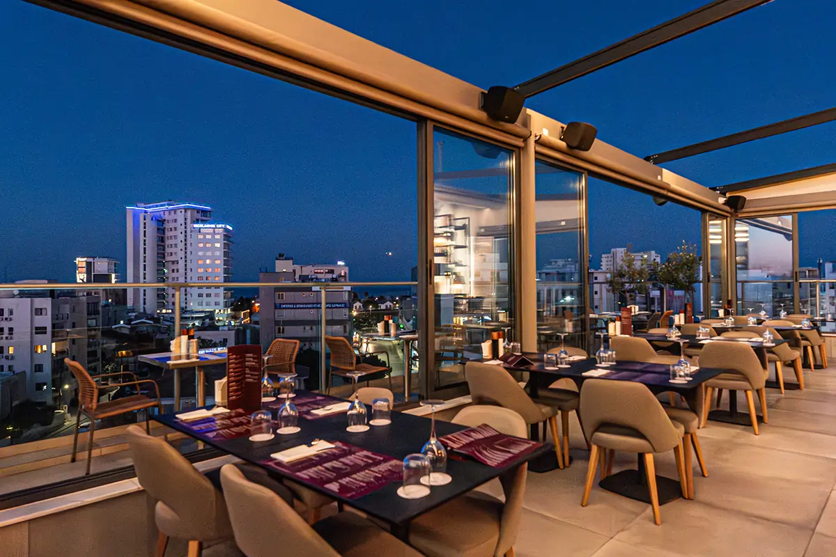 Evening rooftop dining area with panoramic Larnaca city views at Memories Rooftop
