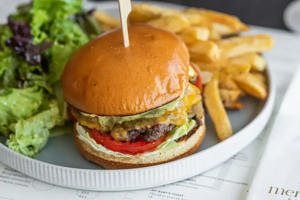Premium Beef Burger with fries and fresh salad at Memories Rooftop Larnaca